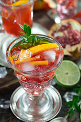 Fruit cocktail, in a glass with natural healthy fruits on a table with kitchen accessories.
