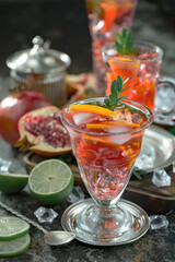 Fruit cocktail, in a glass with natural healthy fruits on a table with kitchen accessories.