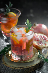 Fruit cocktail, in a glass with natural healthy fruits on a table with kitchen accessories.
