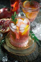 Fruit cocktail, in a glass with natural healthy fruits on a table with kitchen accessories.