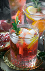 Fruit cocktail, in a glass with natural healthy fruits on a table with kitchen accessories.