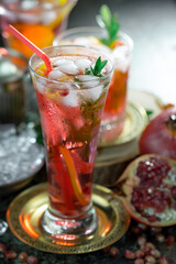 Fruit cocktail, in a glass with natural healthy fruits on a table with kitchen accessories.