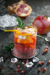 Cocktail in a glass with fruit on an old background.