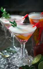 Fruit cocktail, in a glass with natural healthy fruits on a table with kitchen accessories.