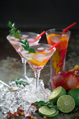 Fruit cocktail, in a glass with natural healthy fruits on a table with kitchen accessories.