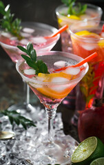 Fruit cocktail, in a glass with natural healthy fruits on a table with kitchen accessories.
