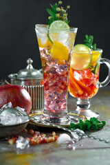 Fruit cocktail, in a glass with natural healthy fruits on a table with kitchen accessories.
