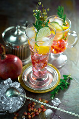 Fruit cocktail, in a glass with natural healthy fruits on a table with kitchen accessories.