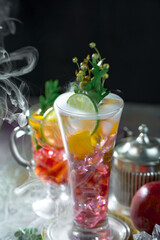 Cocktail in a glass with fruit on an old background.