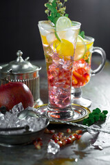 Cocktail in a glass with fruit on an old background.