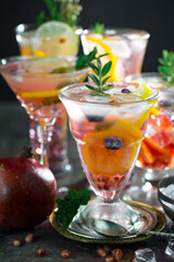 Fruit cocktail, in a glass with natural healthy fruits on a table with kitchen accessories.