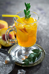 Fruit cocktail, in a glass with natural healthy fruits on a table with kitchen accessories.