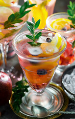 Cocktail in a glass with fruit on an old background.