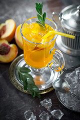Fruit cocktail, in a glass with natural healthy fruits on a table with kitchen accessories.