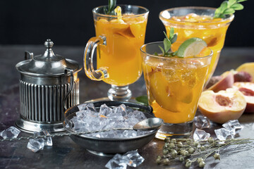 Fruit cocktail, in a glass with natural healthy fruits on a table with kitchen accessories.