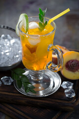 Fruit cocktail, in a glass with natural healthy fruits on a table with kitchen accessories.