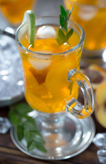 Cocktail in a glass with fruit on an old background.