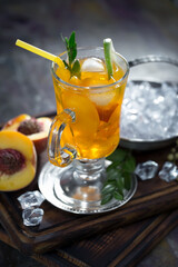 Fruit cocktail, in a glass with natural healthy fruits on a table with kitchen accessories.