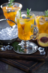 Fruit cocktail, in a glass with natural healthy fruits on a table with kitchen accessories.