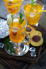 Fruit cocktail, in a glass with natural healthy fruits on a table with kitchen accessories.