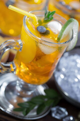 Fruit cocktail, in a glass with natural healthy fruits on a table with kitchen accessories.