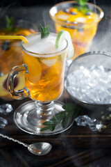 Fruit cocktail, in a glass with natural healthy fruits on a table with kitchen accessories.