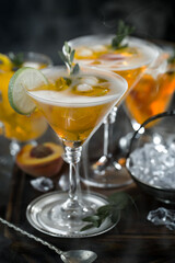 Fruit cocktail, in a glass with natural healthy fruits on a table with kitchen accessories.