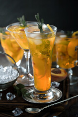Fruit cocktail, in a glass with natural healthy fruits on a table with kitchen accessories.