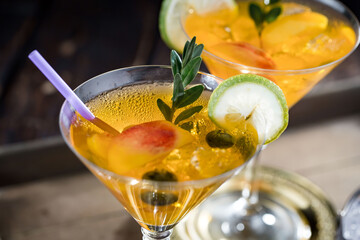 Fruit cocktail, in a glass with natural healthy fruits on a table with kitchen accessories.