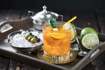 Fruit cocktail, in a glass with natural healthy fruits on a table with kitchen accessories.