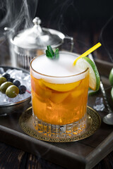 Fruit cocktail, in a glass with natural healthy fruits on a table with kitchen accessories.