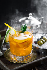 Fruit cocktail, in a glass with natural healthy fruits on a table with kitchen accessories.