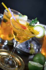 Fruit cocktail, in a glass with natural healthy fruits on a table with kitchen accessories.