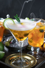 Fruit cocktail, in a glass with natural healthy fruits on a table with kitchen accessories.