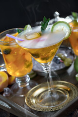 Fruit cocktail, in a glass with natural healthy fruits on a table with kitchen accessories.