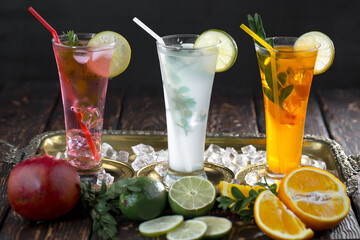 Fruit cocktail, in a glass with natural healthy fruits on a table with kitchen accessories.