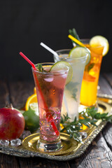 Fruit cocktail, in a glass with natural healthy fruits on a table with kitchen accessories.
