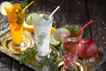 Fruit cocktail, in a glass with natural healthy fruits on a table with kitchen accessories.