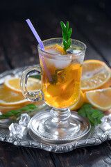 Fruit cocktail, in a glass with natural healthy fruits on a table with kitchen accessories.