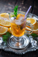 Cocktail in a glass with fruit on an old background.