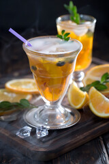 Cocktail in a glass with fruit on an old background.
