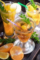 Cocktail in a glass with fruit on an old background.