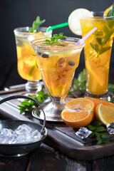 Cocktail in a glass with fruit on an old background.