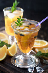 Fruit cocktail, in a glass with natural healthy fruits on a table with kitchen accessories.