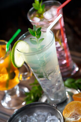 Fruit cocktail, in a glass with natural healthy fruits on a table with kitchen accessories.