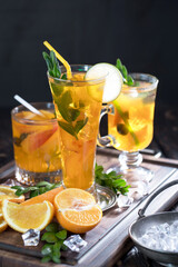 Fruit cocktail, in a glass with natural healthy fruits on a table with kitchen accessories.