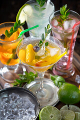 Cocktail in a glass with fruit on an old background.