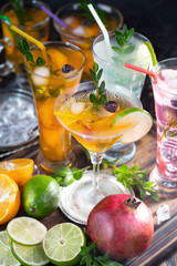 Fruit cocktail, in a glass with natural healthy fruits on a table with kitchen accessories.