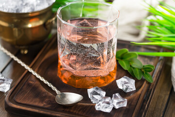 Cocktail in a glass with fruit on an old background.