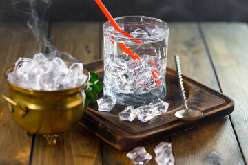 Fruit cocktail, in a glass with natural healthy fruits on a table with kitchen accessories.